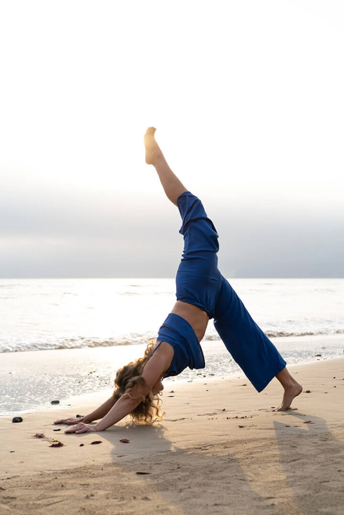 A yoga instructor practicing by the sea
