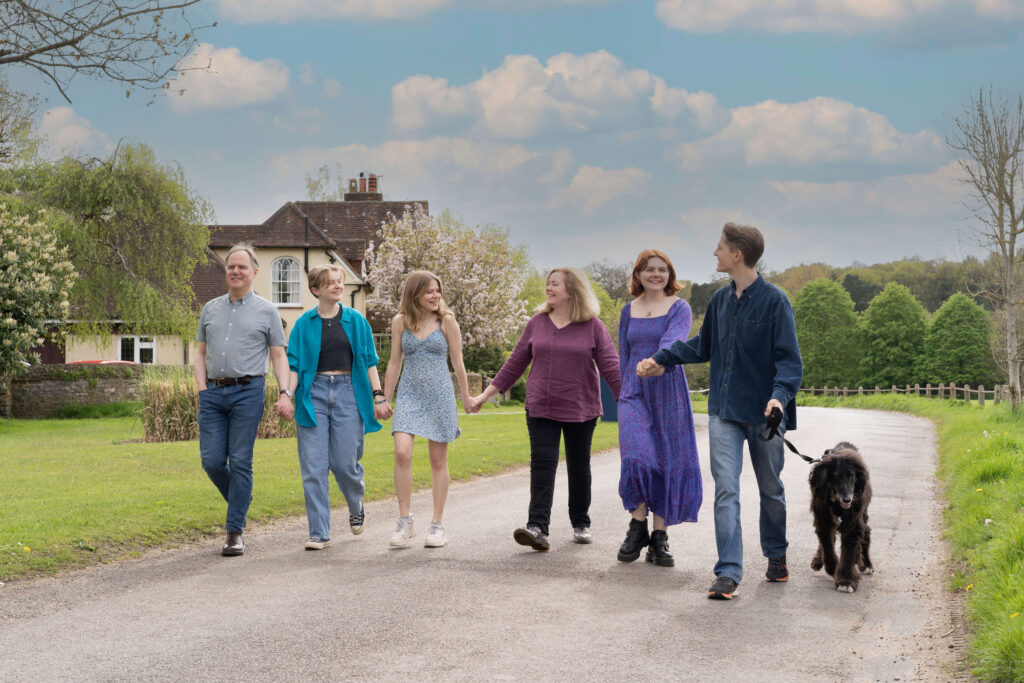 a family portrait of six people and a dog