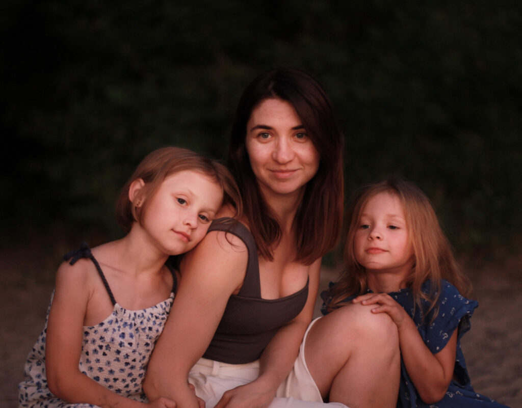 a family photograph of Mum with two young daughters
