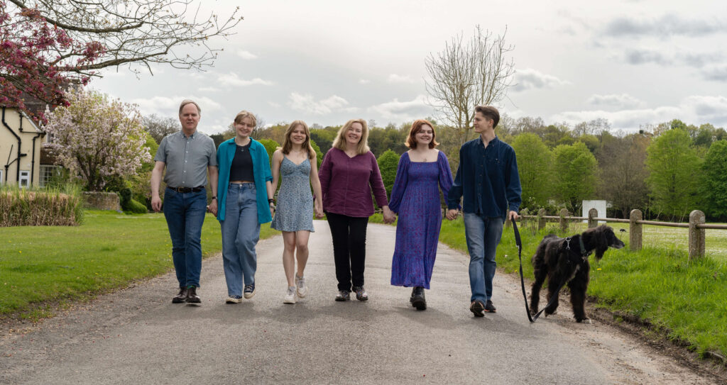 A family portrait of six adults and a dog